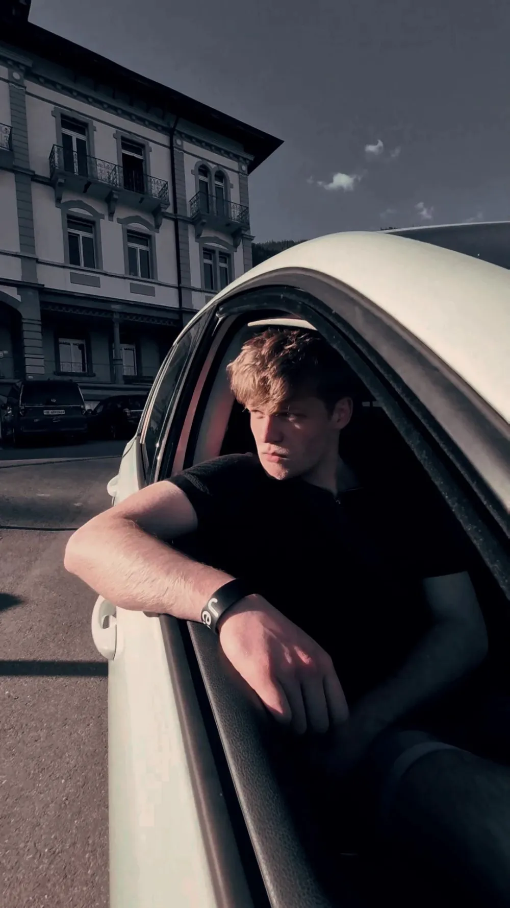 Lukas Goss leaning out of a car window in the sun