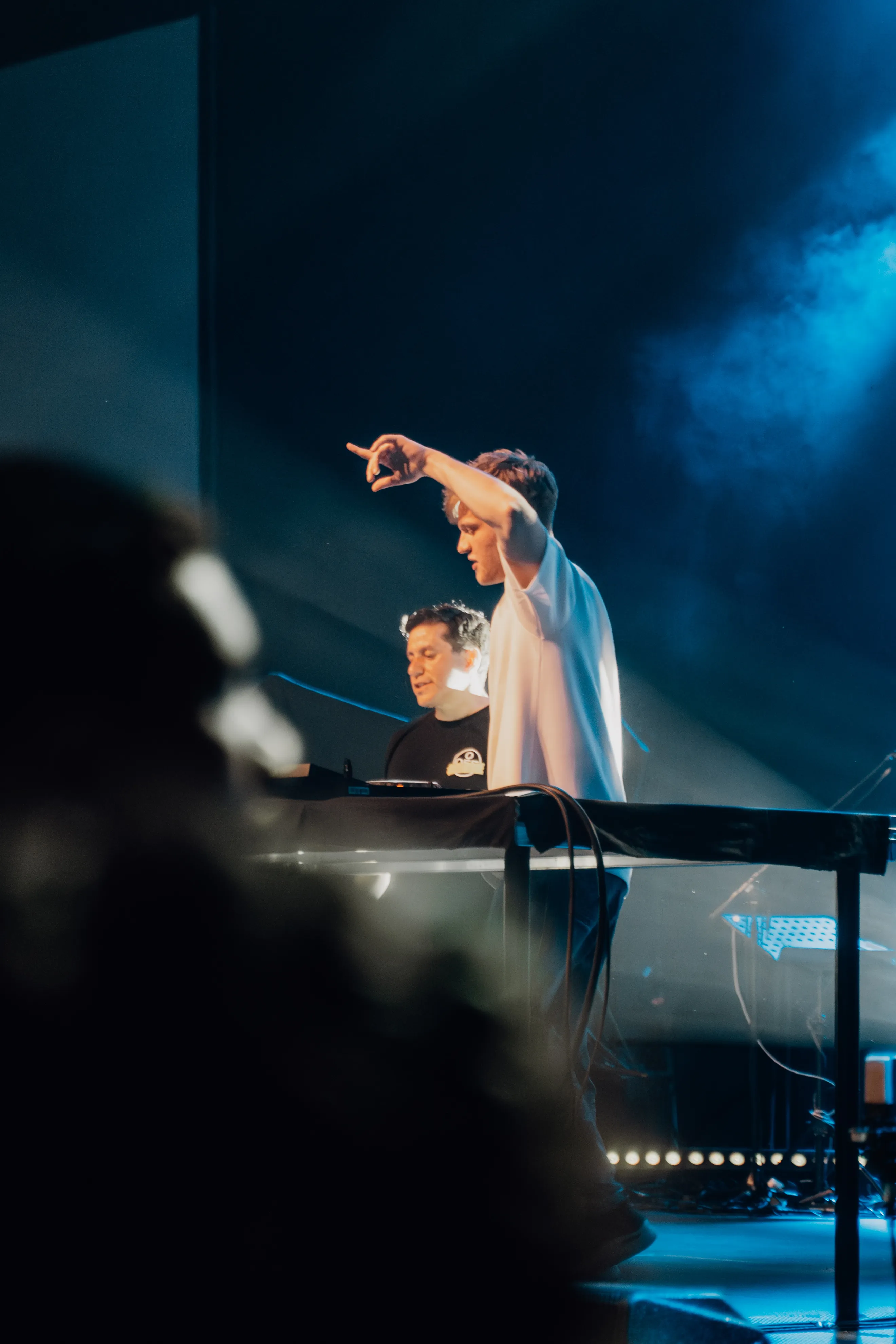 Lukas Goss pointing from the stage in blue light next to DJ Jesus Loves Electro at the decks, BUJU 2026