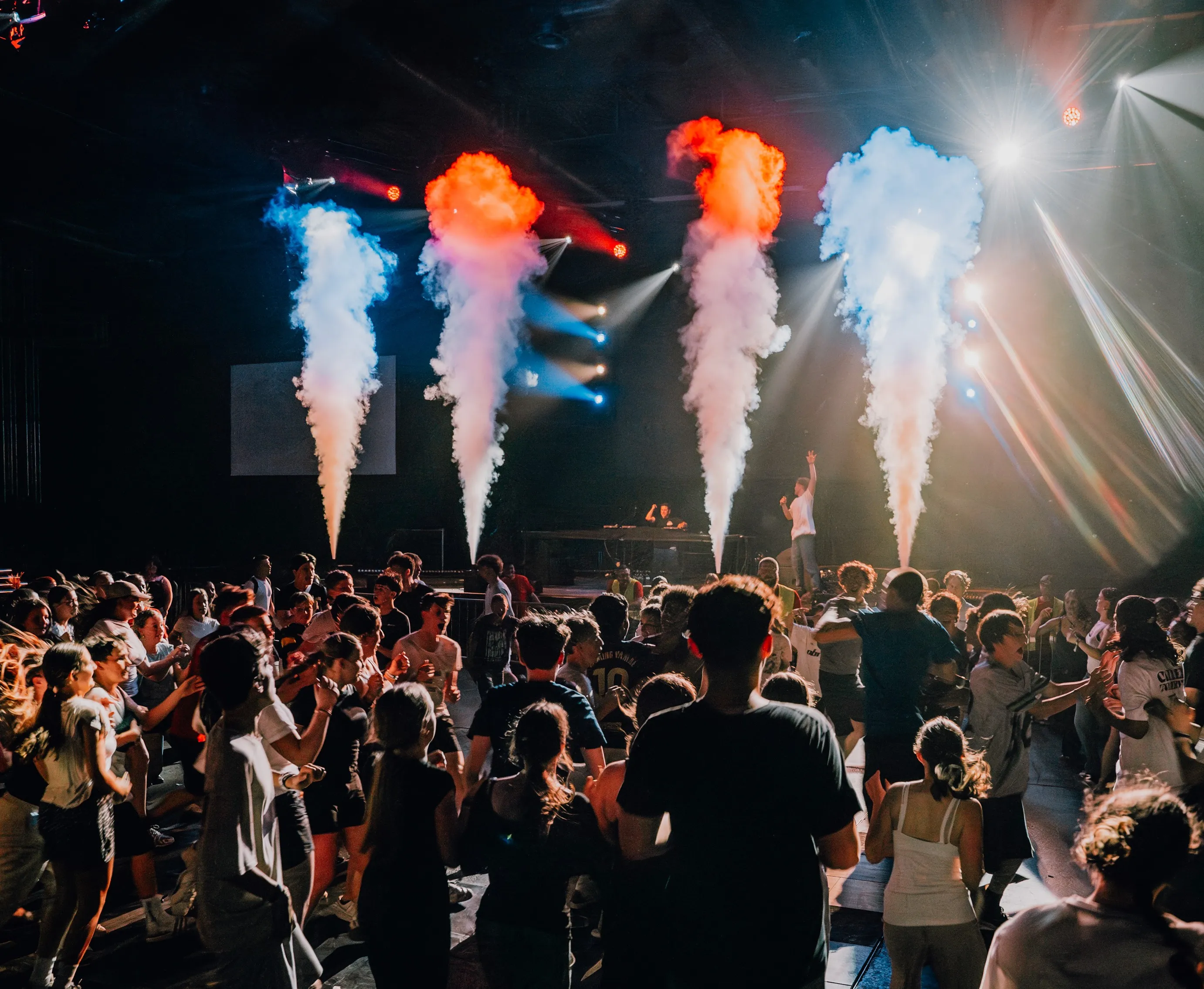 Lukas Goss on stage behind colourful pyro columns and a dancing crowd at BUJU 2026